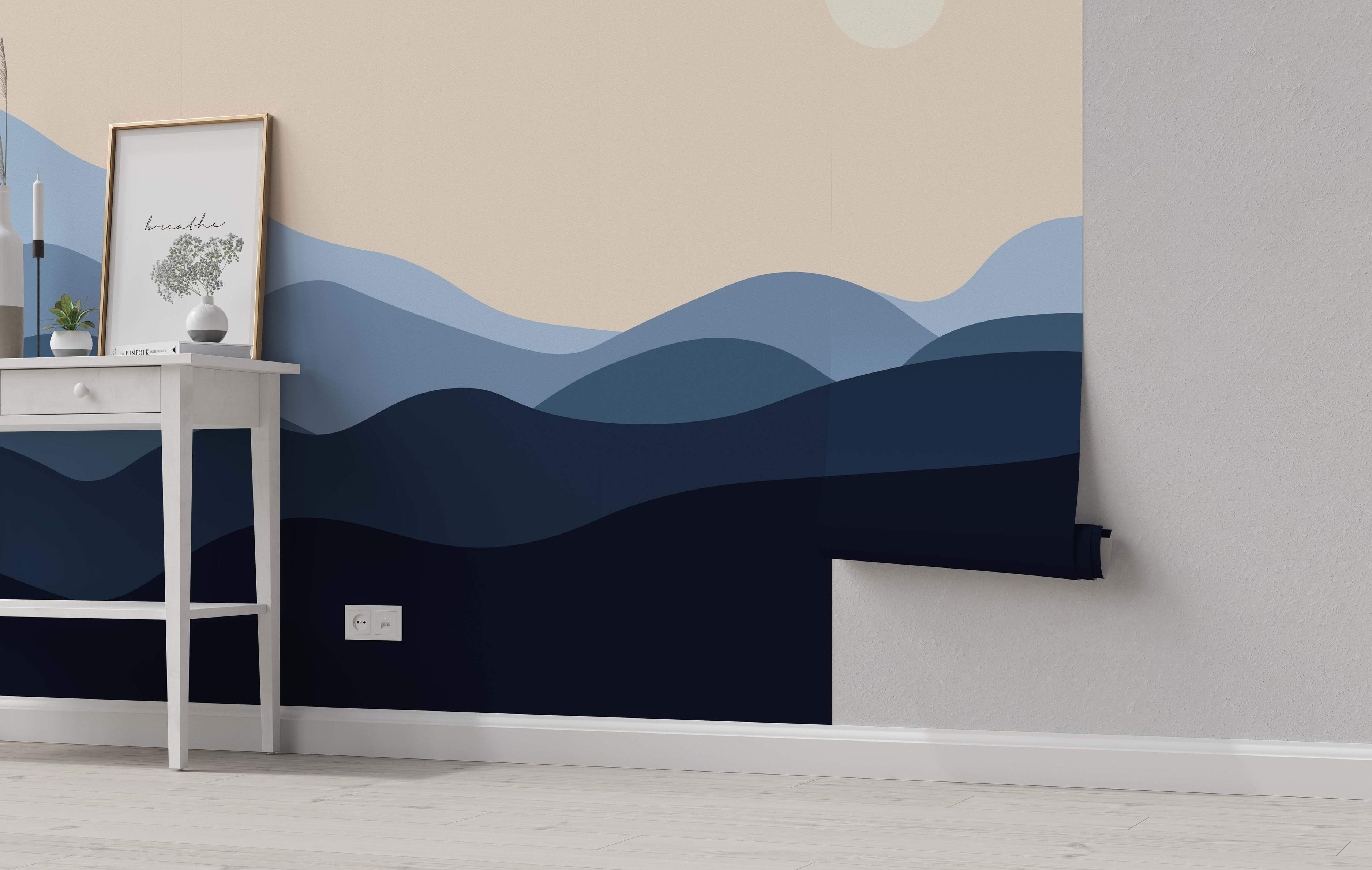 Mural featuring layered, rolling hills in various shades of blue beneath a pale beige sky with a light circle.