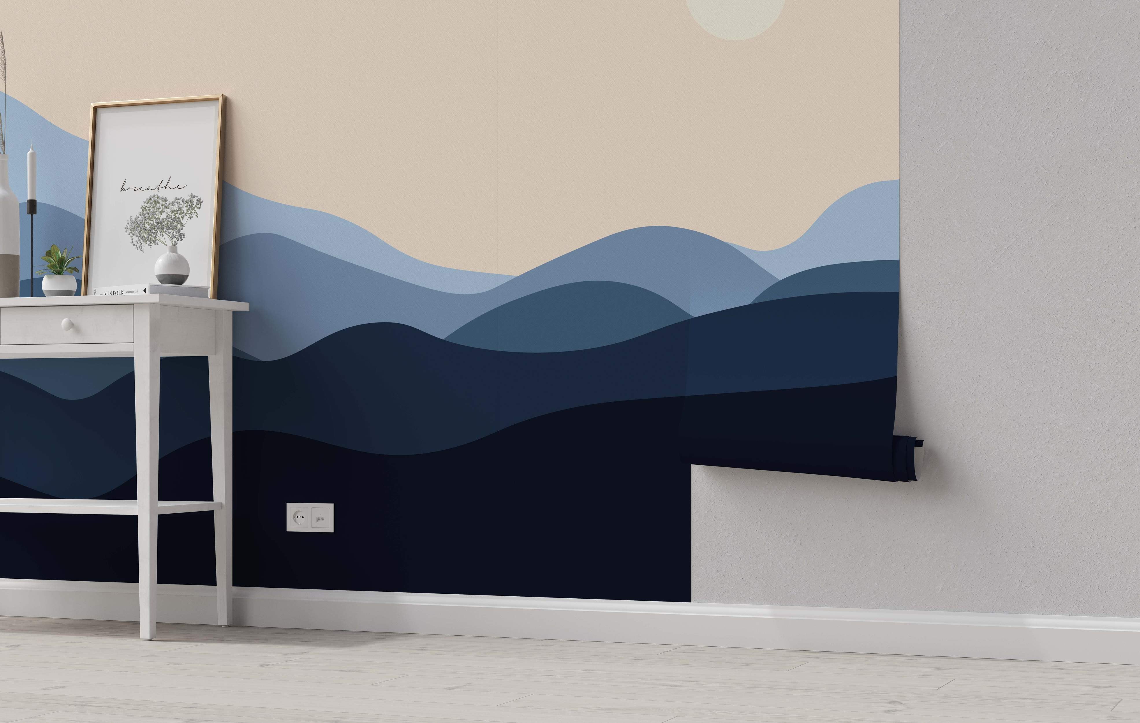 Mural featuring layered, rolling hills in various shades of blue beneath a pale beige sky with a light circle.