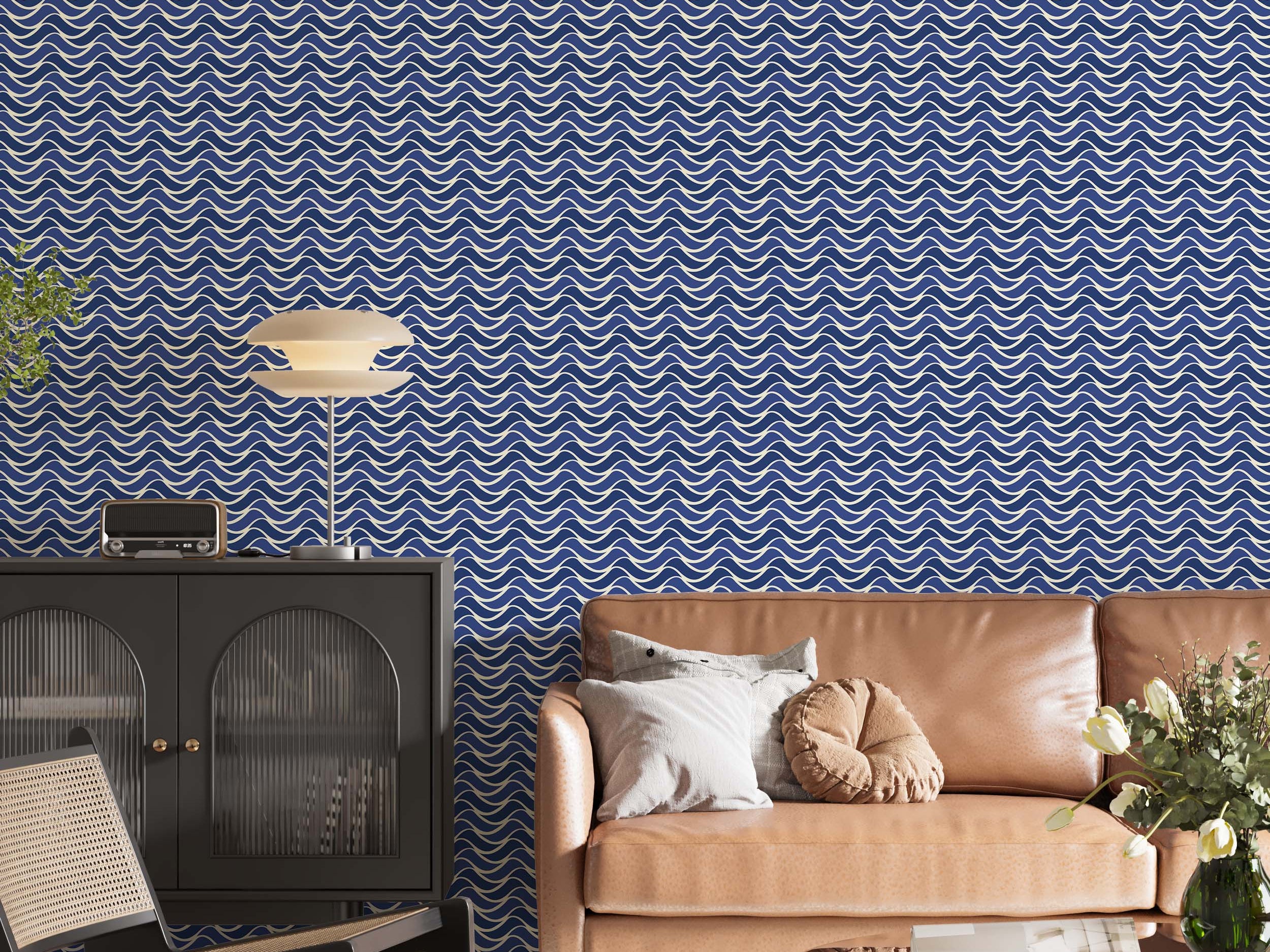 Wallpaper with a repeating pattern of interlocking scalloped waves in cream and multiple shades of blue, creating a fluid design.