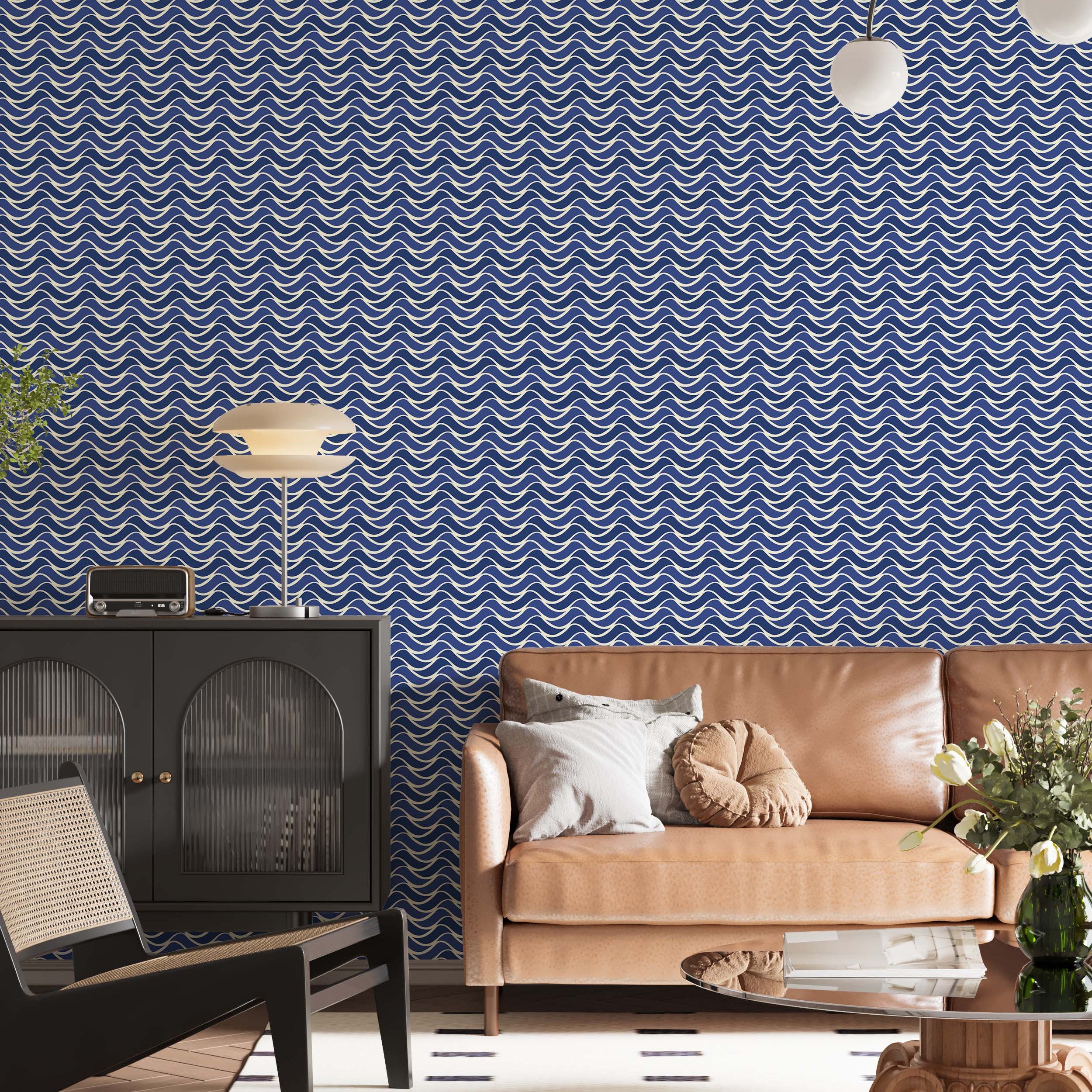 Wallpaper with a repeating pattern of interlocking scalloped waves in cream and multiple shades of blue, creating a fluid design.