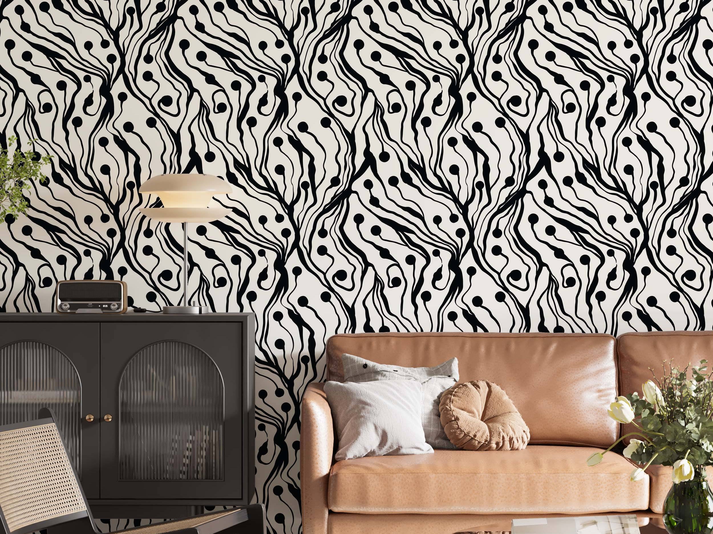 Abstract wallpaper featuring bold, wavy black lines and scattered black dots resembling organic forms on a cream background.