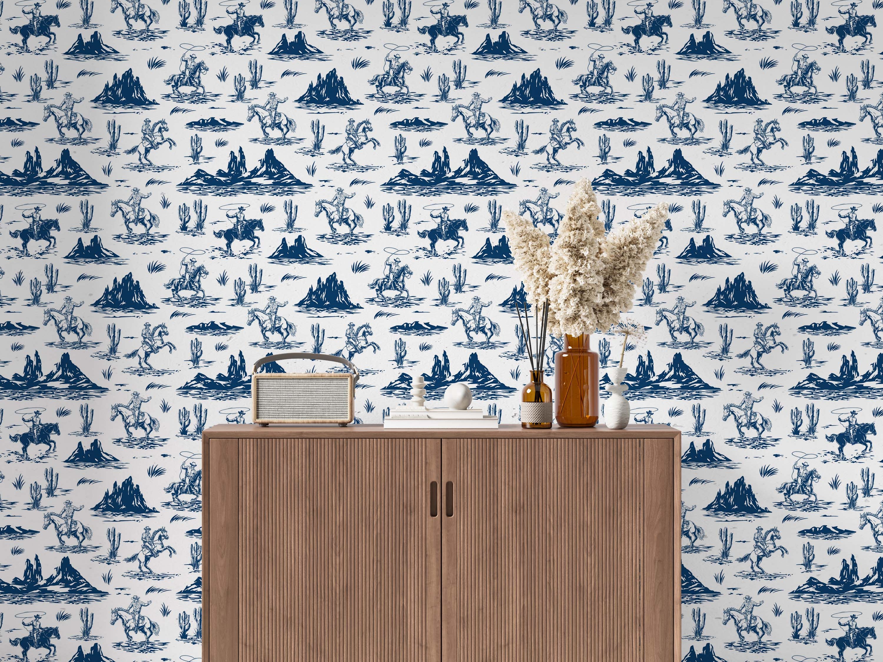 Western-themed wallpaper with blue illustrations of cowboys on horseback, cacti, and desert mountains on a white background.