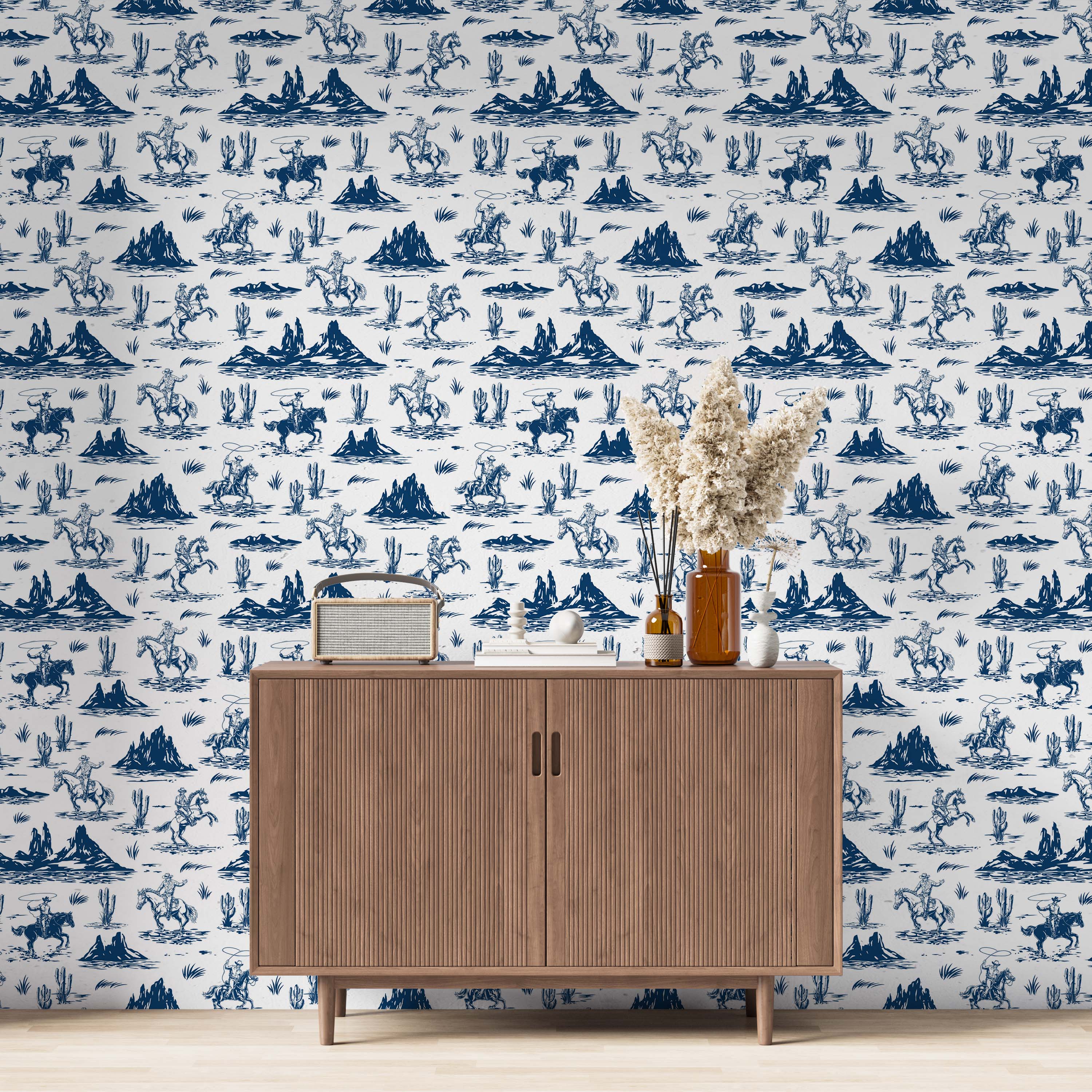 Western-themed wallpaper with blue illustrations of cowboys on horseback, cacti, and desert mountains on a white background.