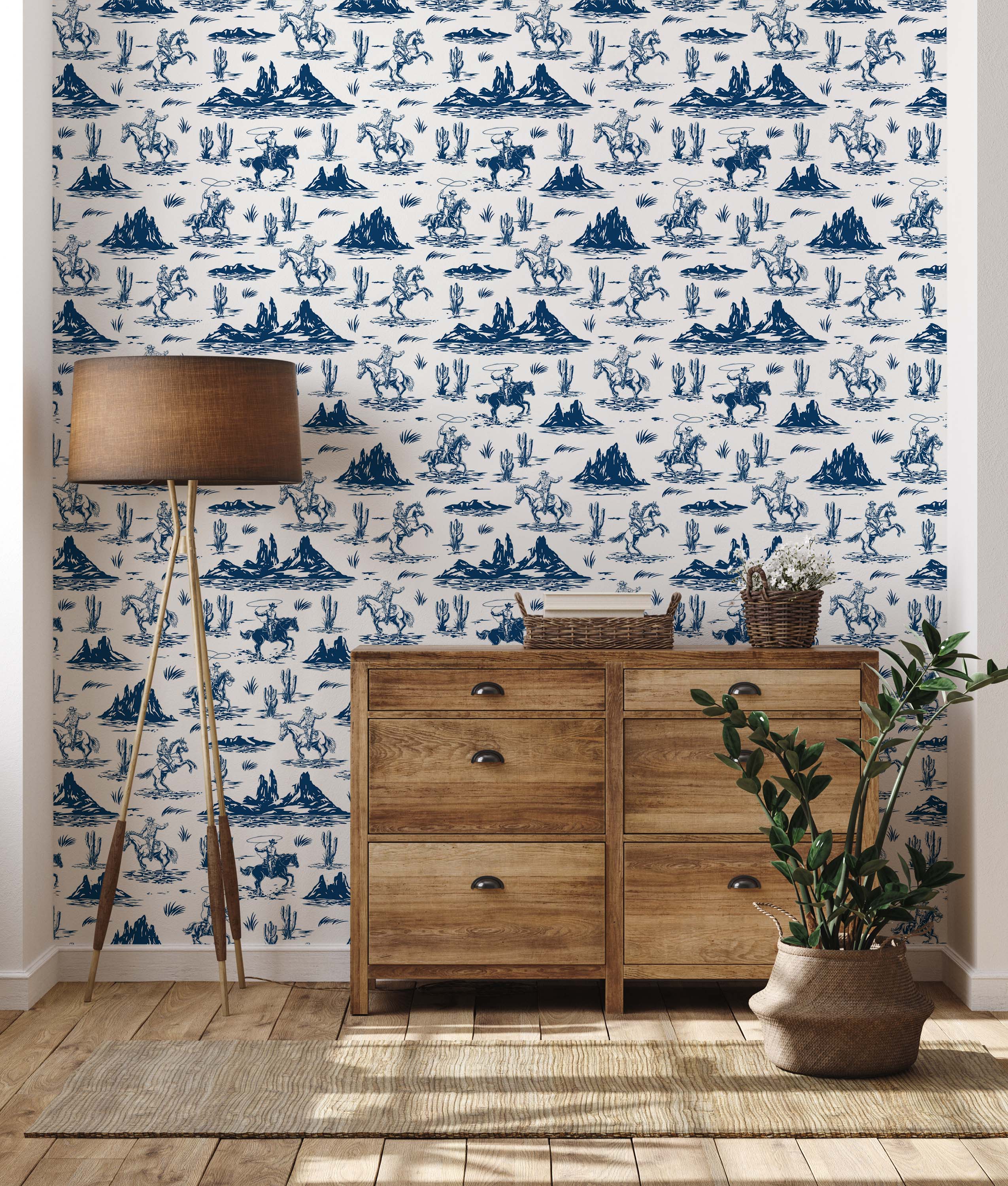 A western toile wallpaper featuring illustrations of cowboys, horses, and cacti in navy blue on a cream background.