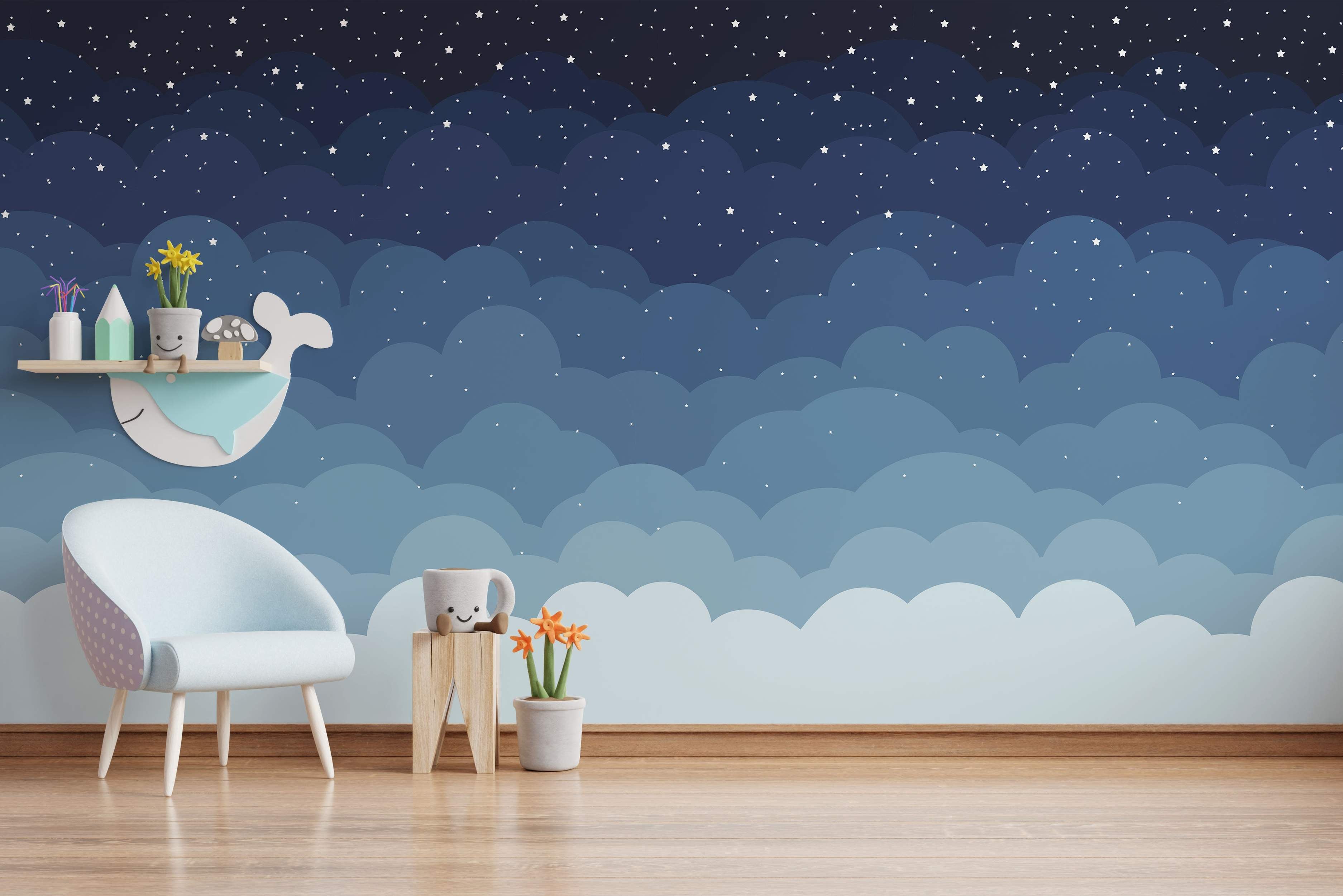 Blue ombre mural with clouds and a playful whale against a starry night sky.