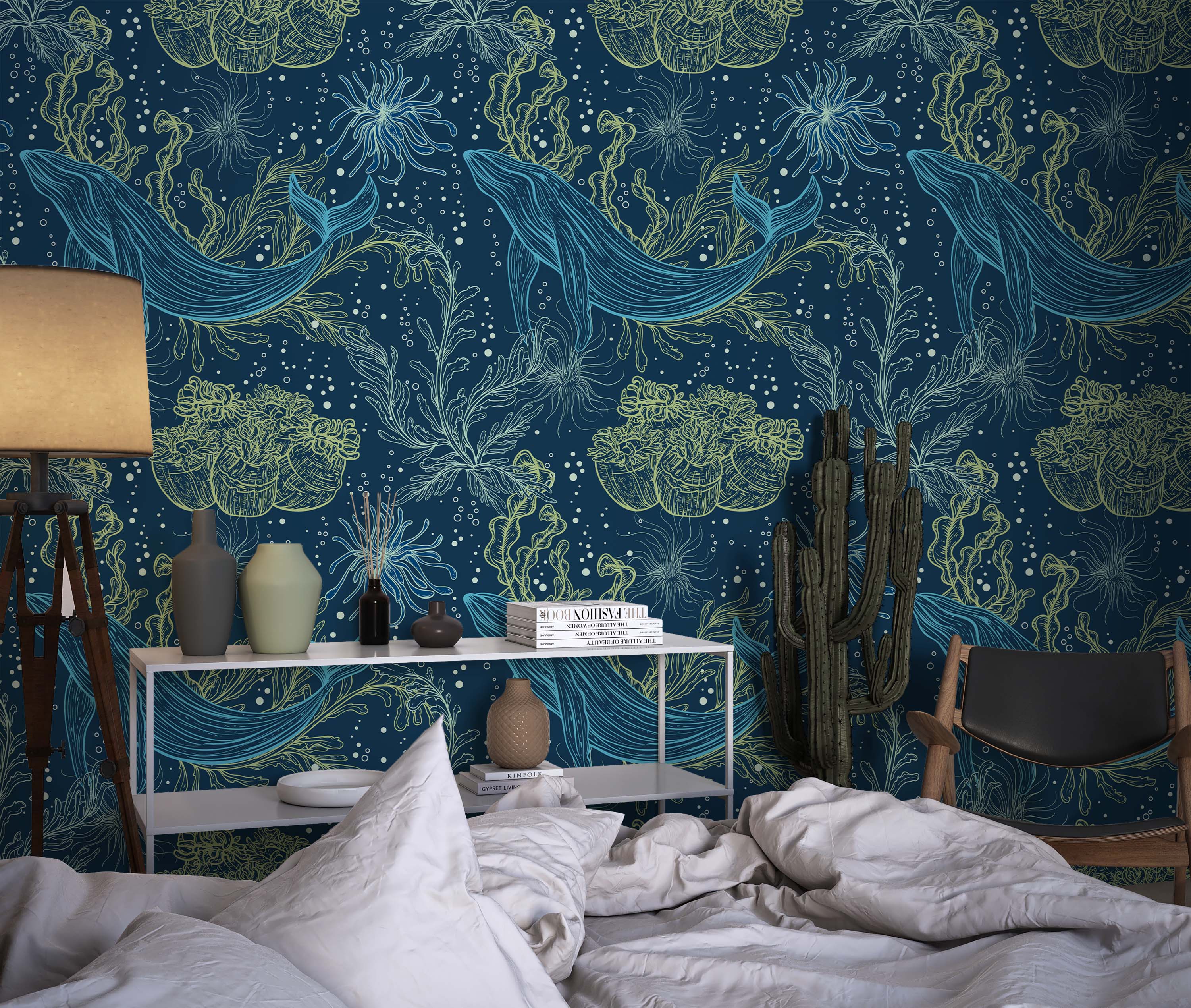Illustrative wallpaper featuring light blue whales and lime green seaweed on a dark navy blue background with small bubbles.
