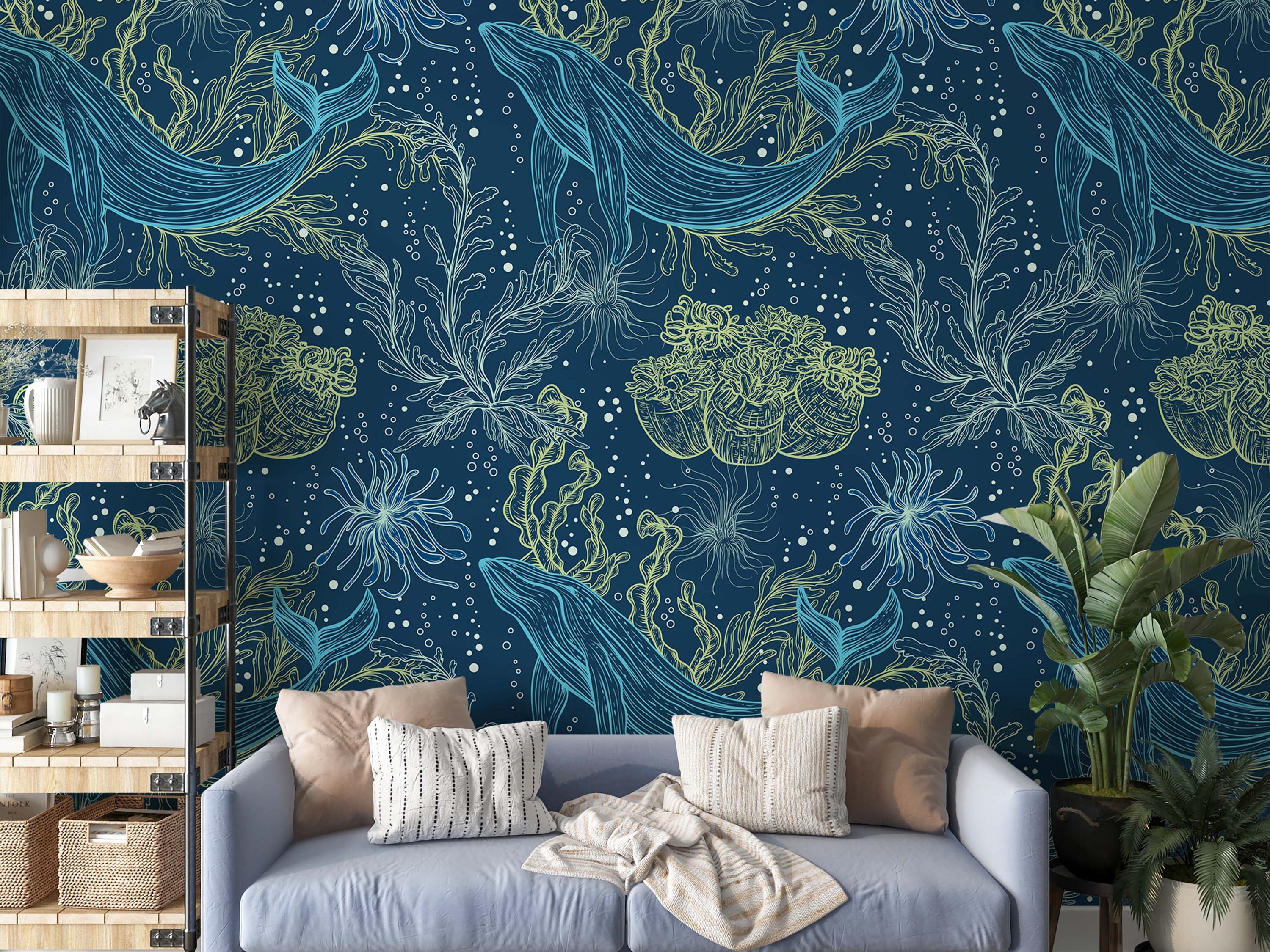 A wallpaper with a repeating pattern of hand-drawn whales, seaweed, and anemones in blue and lime-green on a navy background.