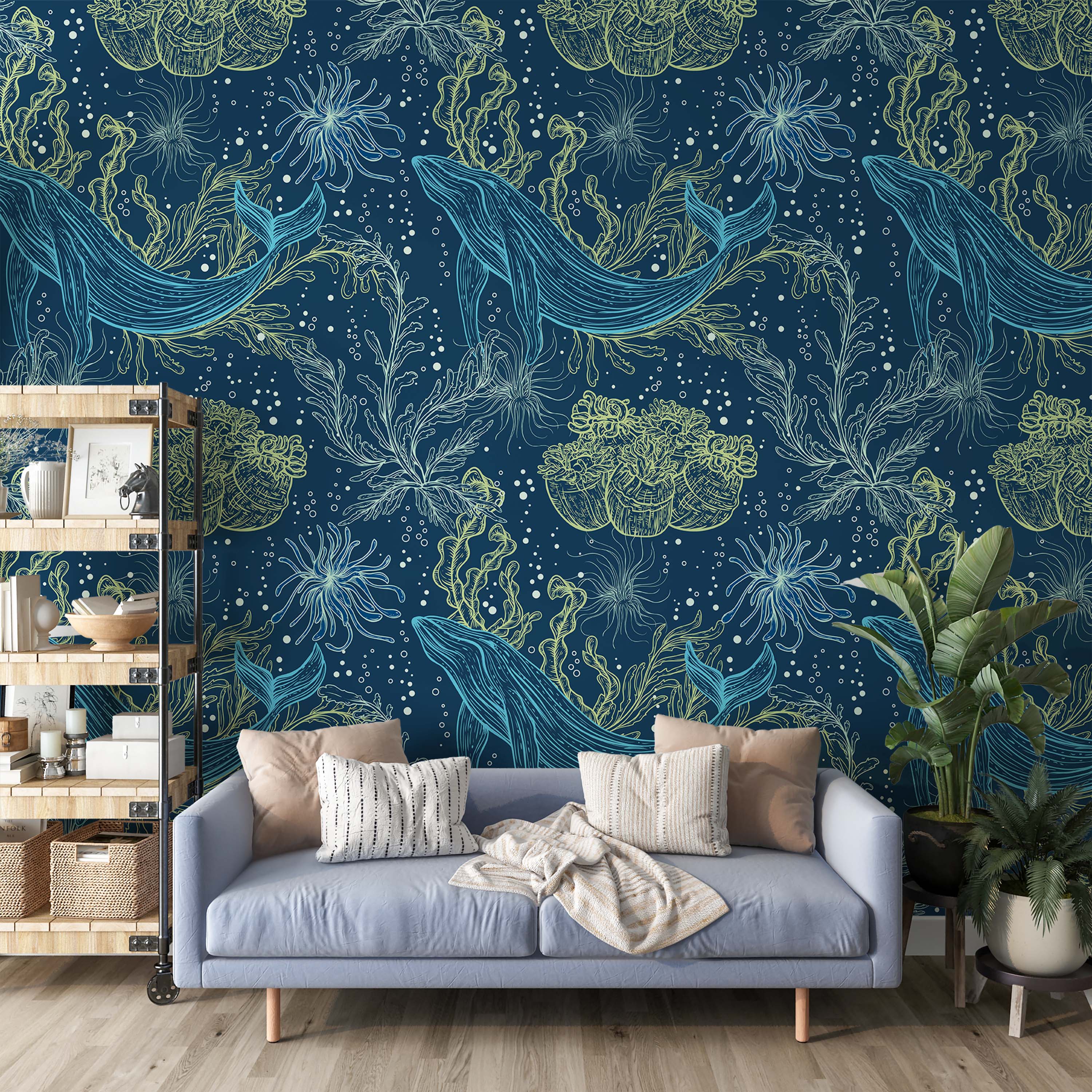 A wallpaper with a repeating pattern of hand-drawn whales, seaweed, and anemones in blue and lime-green on a navy background.