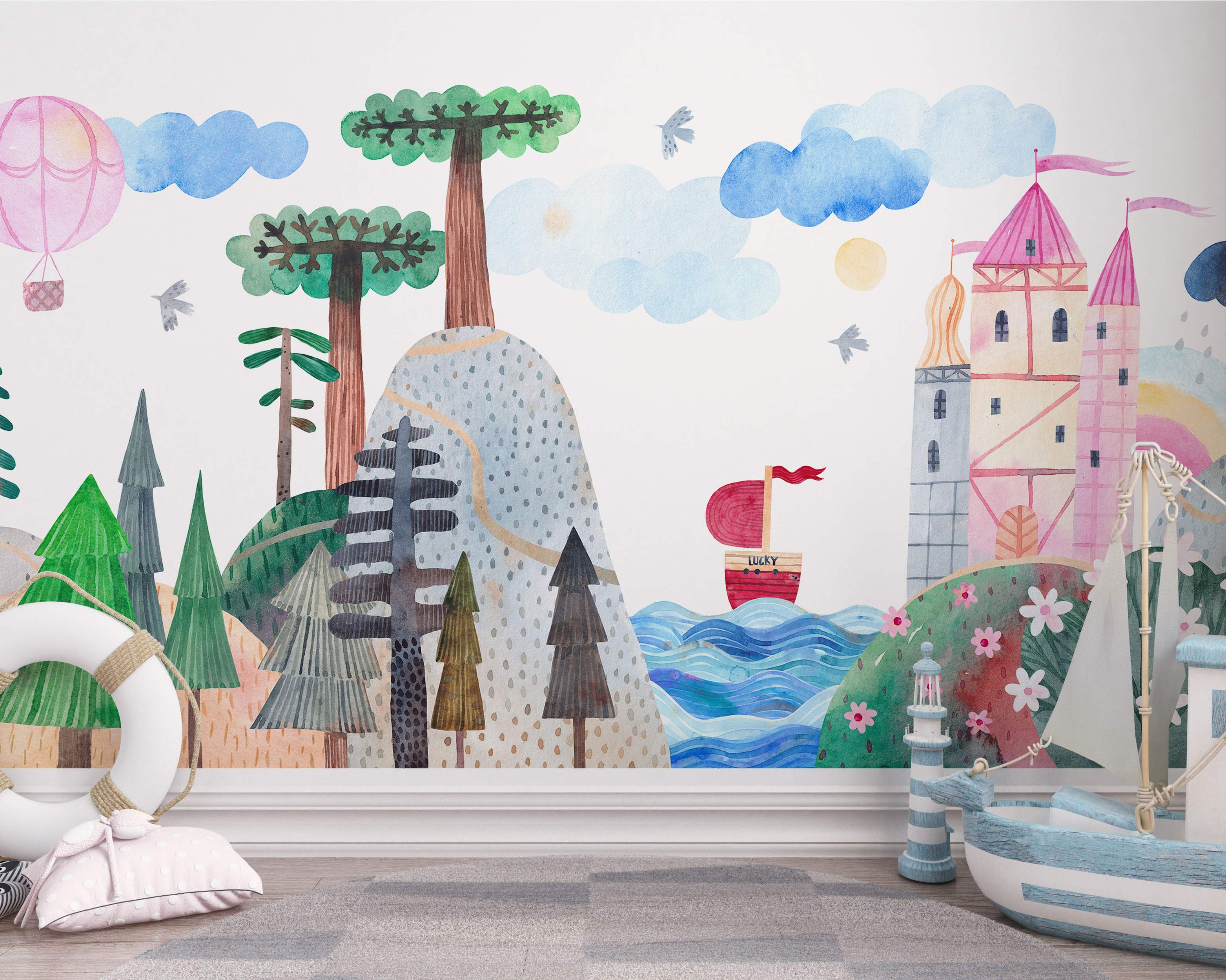 Whimsical watercolor mural featuring a pastel landscape with a pink castle, green trees, blue sea, a boat, and a hot air balloon.