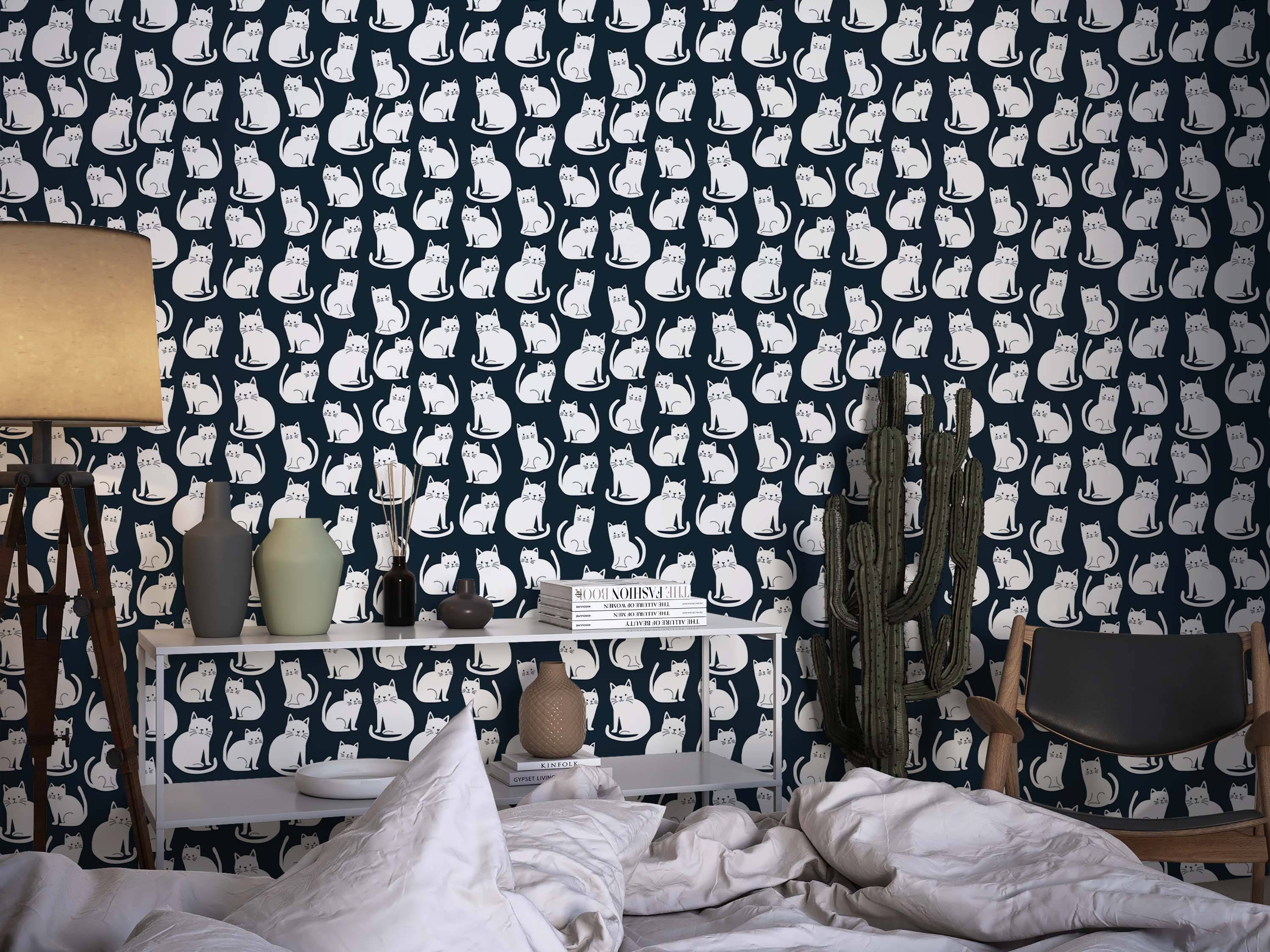 Wallpaper featuring a repeating pattern of stylized white cats sitting on a dark navy blue background.
