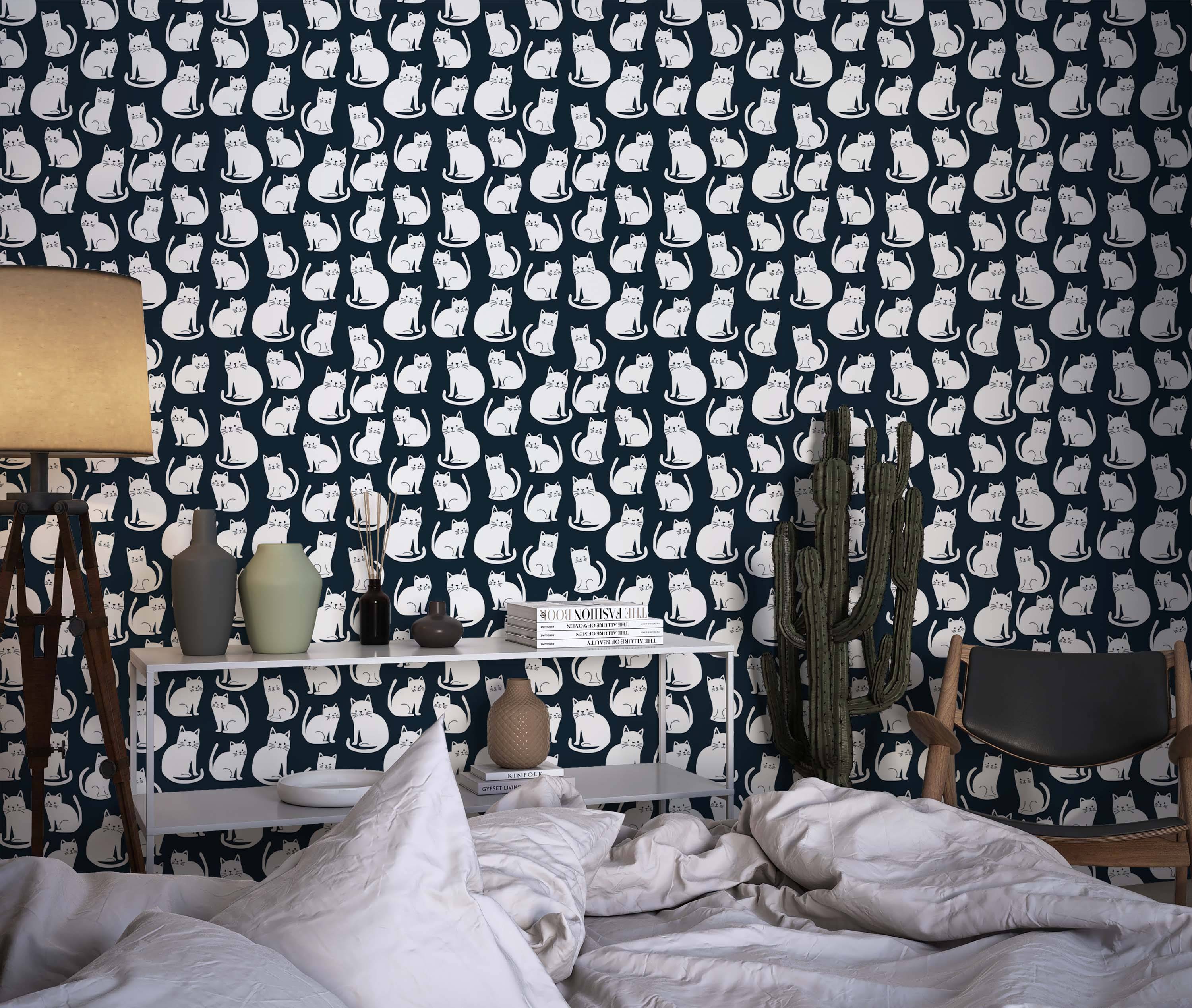 Wallpaper featuring a repeating pattern of stylized white cats sitting on a dark navy blue background.