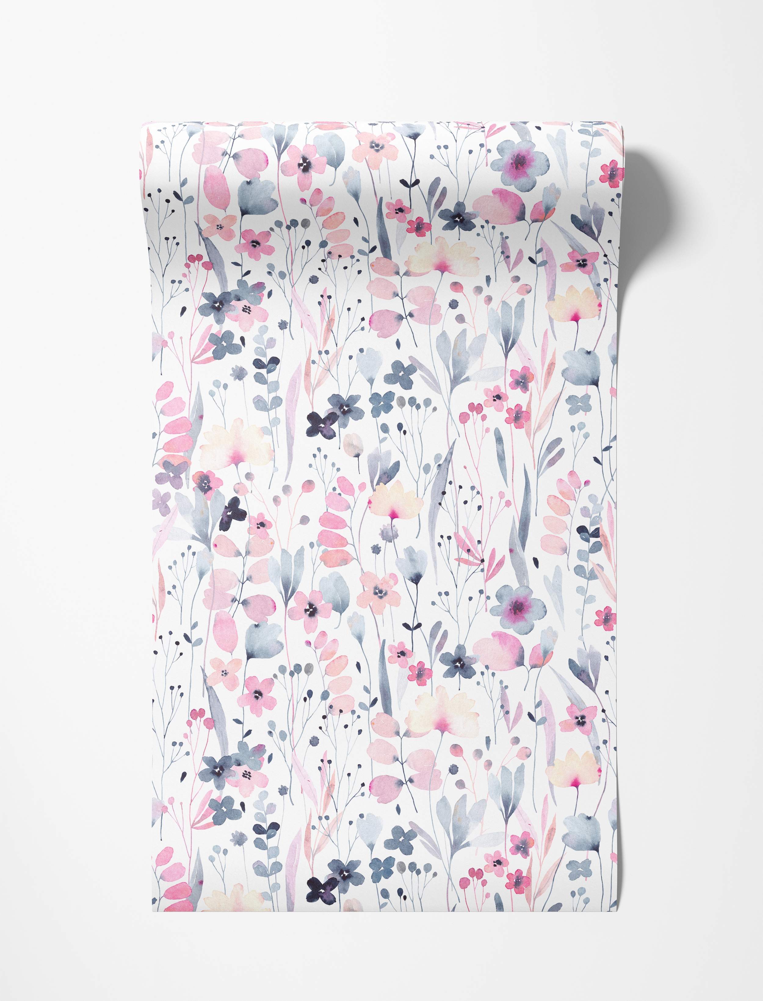 Delicate watercolor floral wallpaper with pink, blue-grey, and pale yellow wildflowers scattered on white.