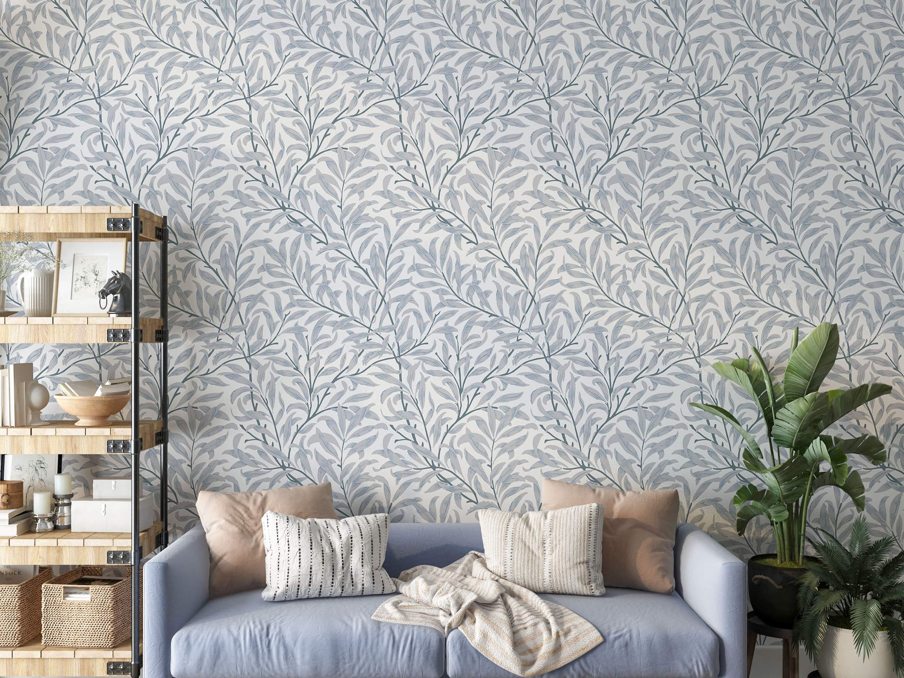 Wallpaper featuring intertwined gray-blue branches and light blue-gray willow leaves on a soft white background.