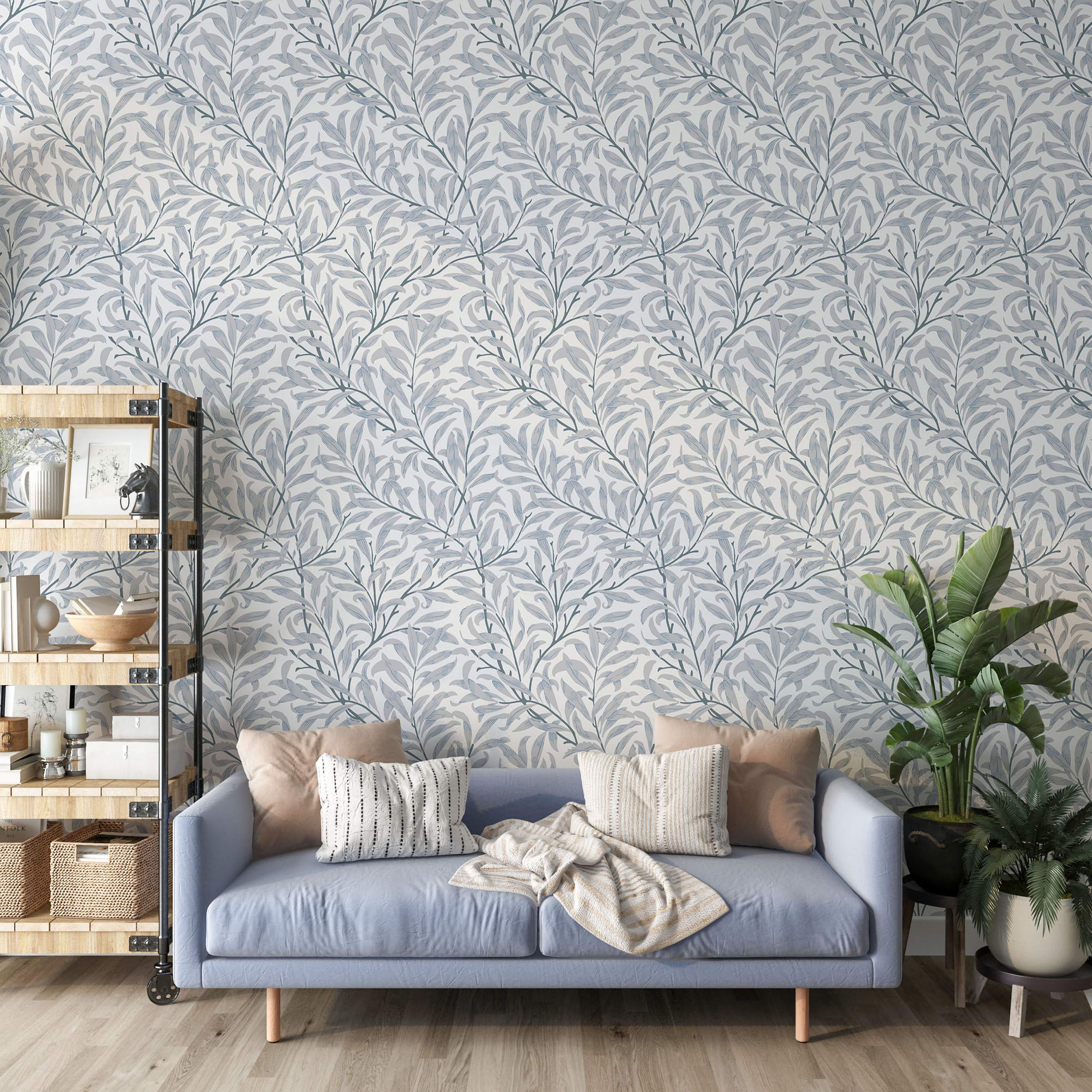 Wallpaper featuring intertwined gray-blue branches and light blue-gray willow leaves on a soft white background.