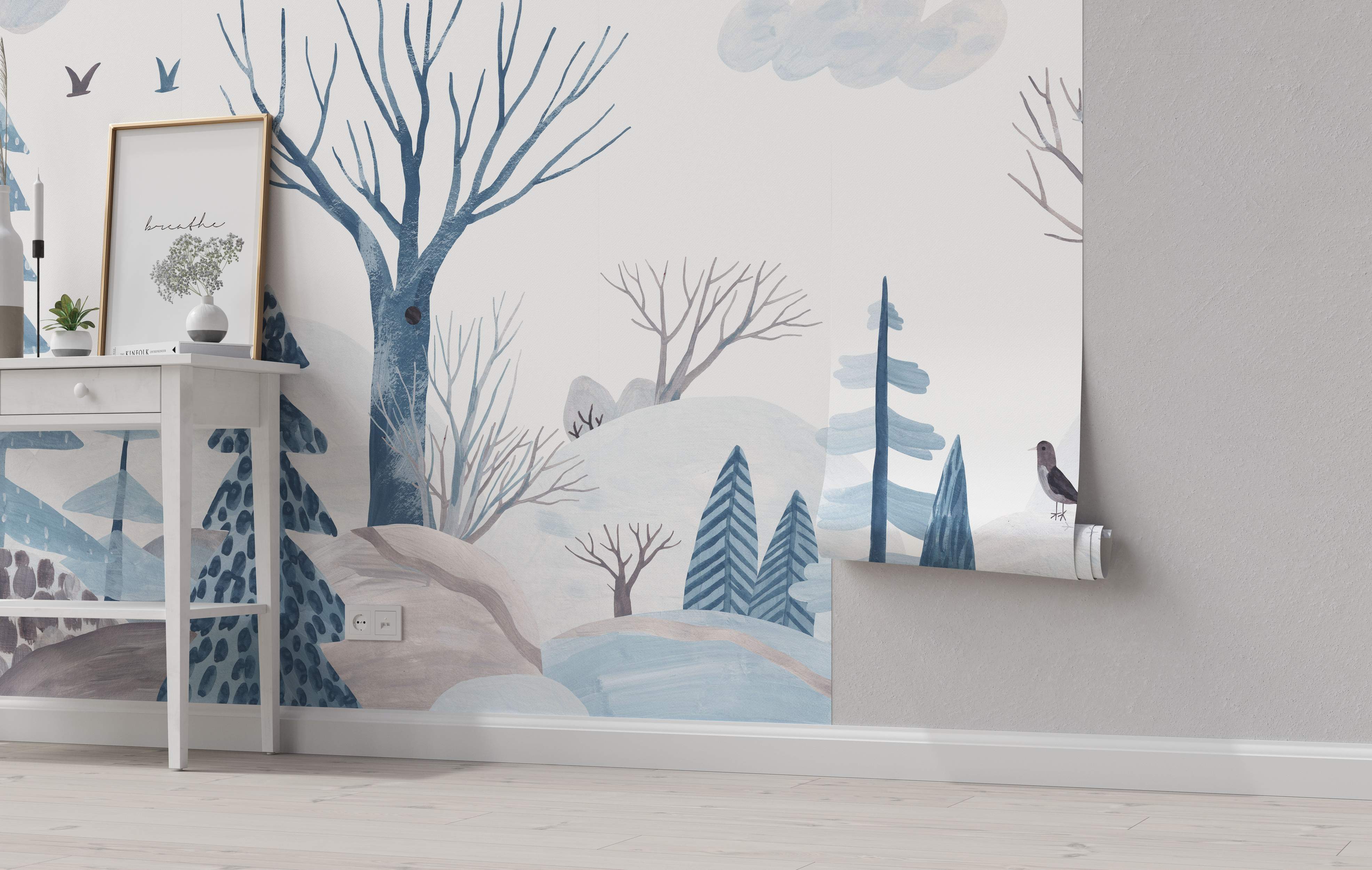Stylized winter forest mural featuring bare and pine trees, hills, and birds painted in blue, gray, and taupe watercolors.