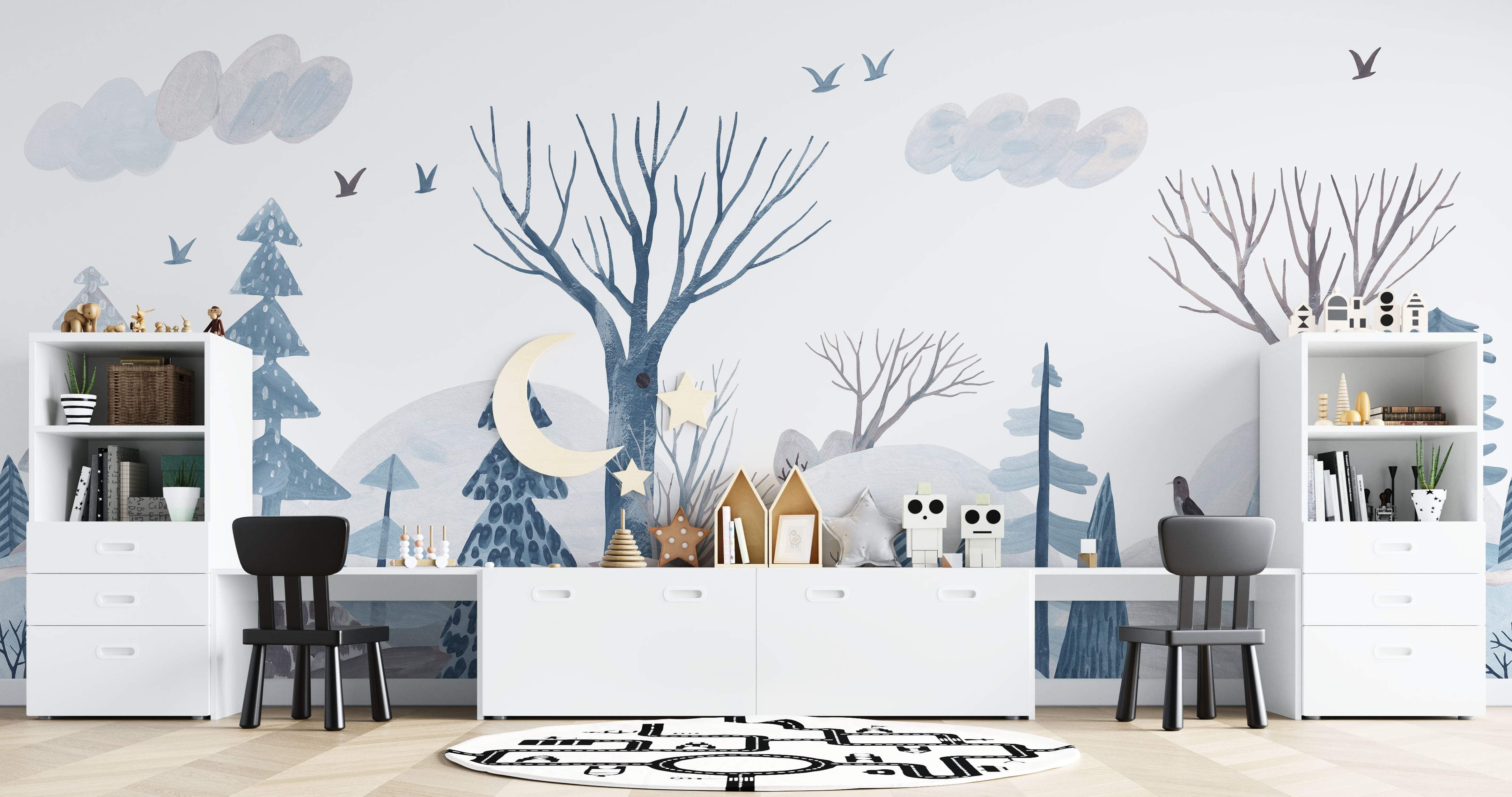 Mural depicting a stylized winter forest scene with blue and gray trees, hills, clouds, and birds on a white background.