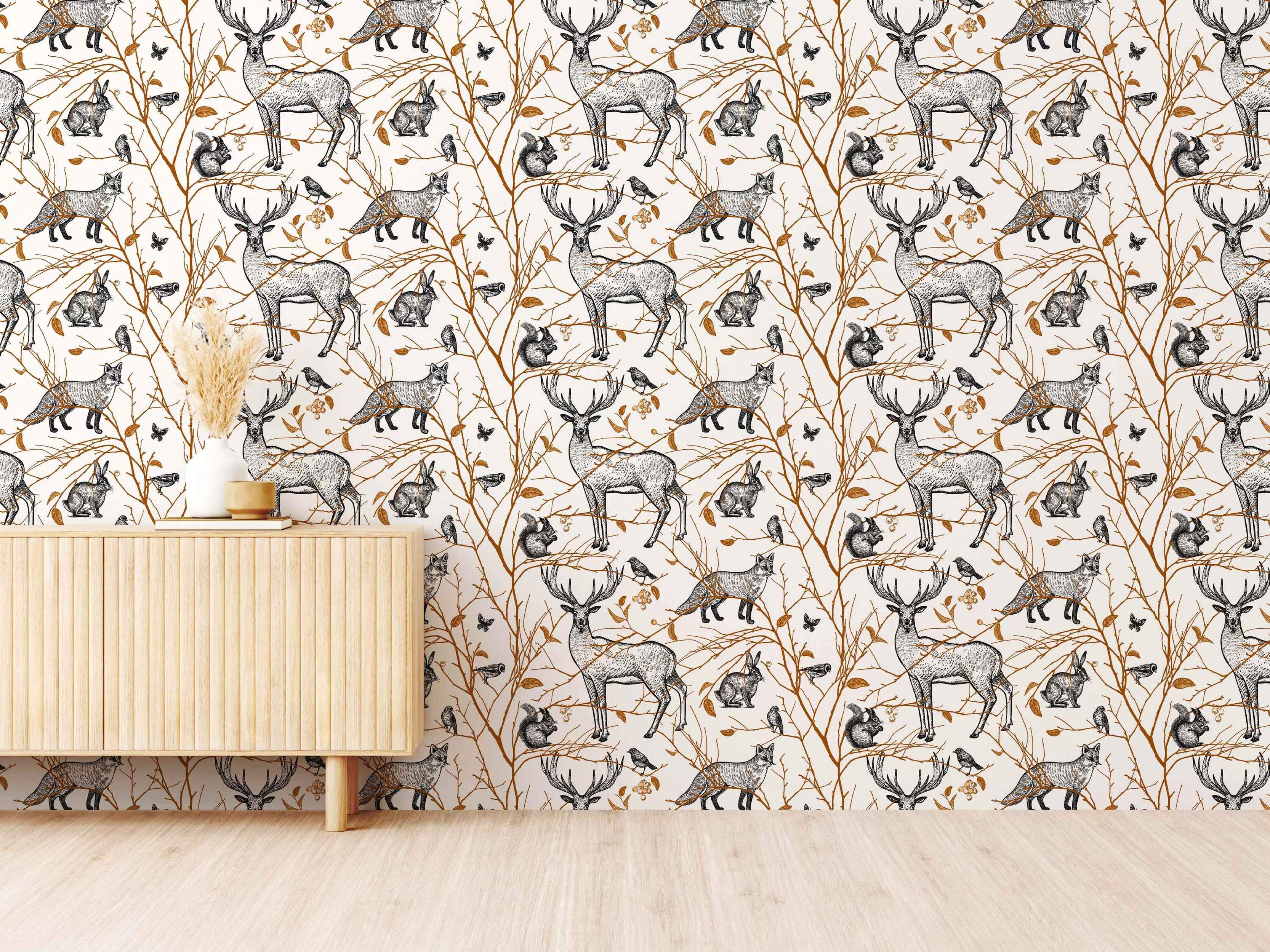 Repeating wallpaper pattern featuring black sketch-style woodland animals like deer, foxes, and rabbits on brown branches over a cream background.
