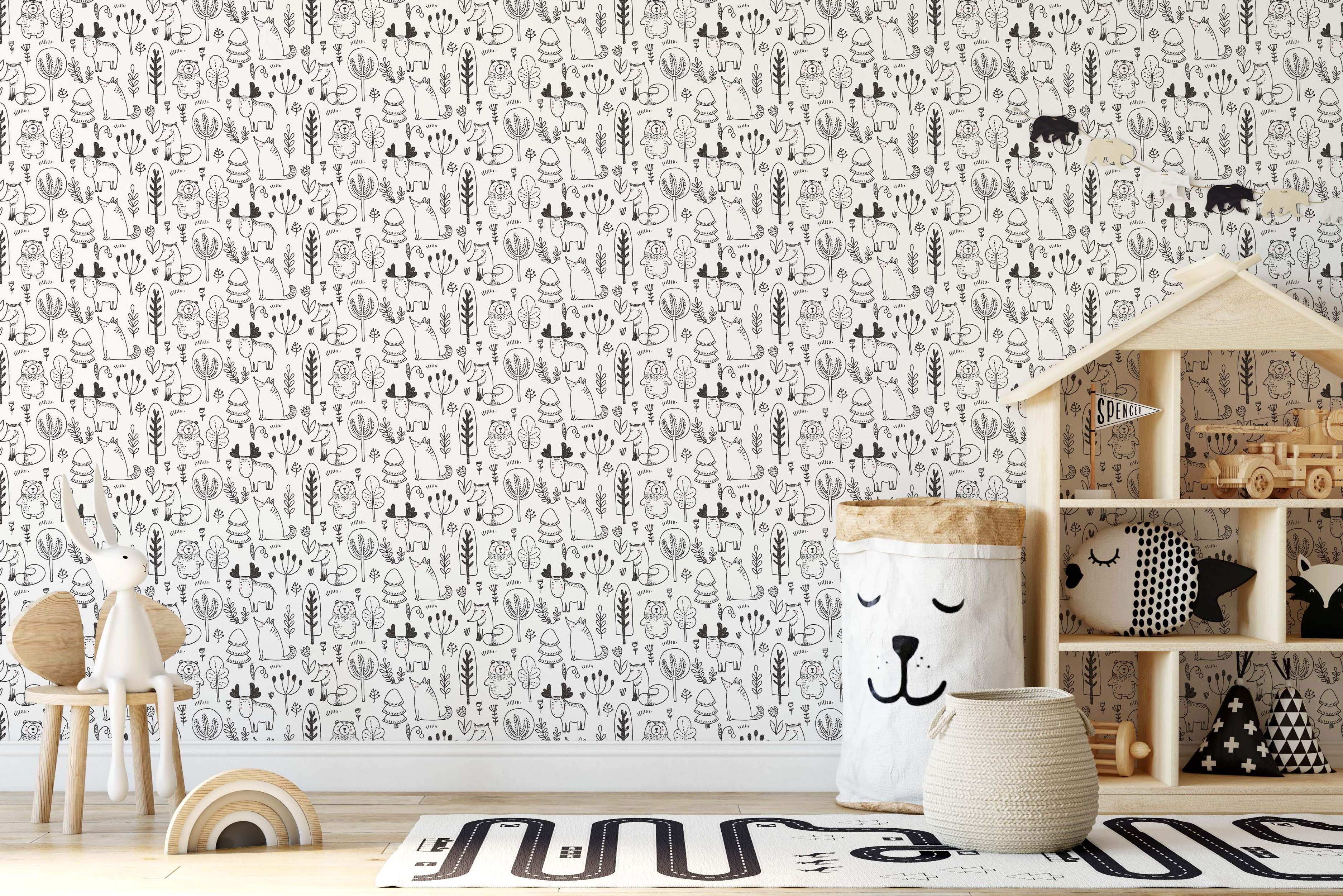 Illustrative wallpaper featuring hand-drawn woodland animals and trees in black line art on a white background.