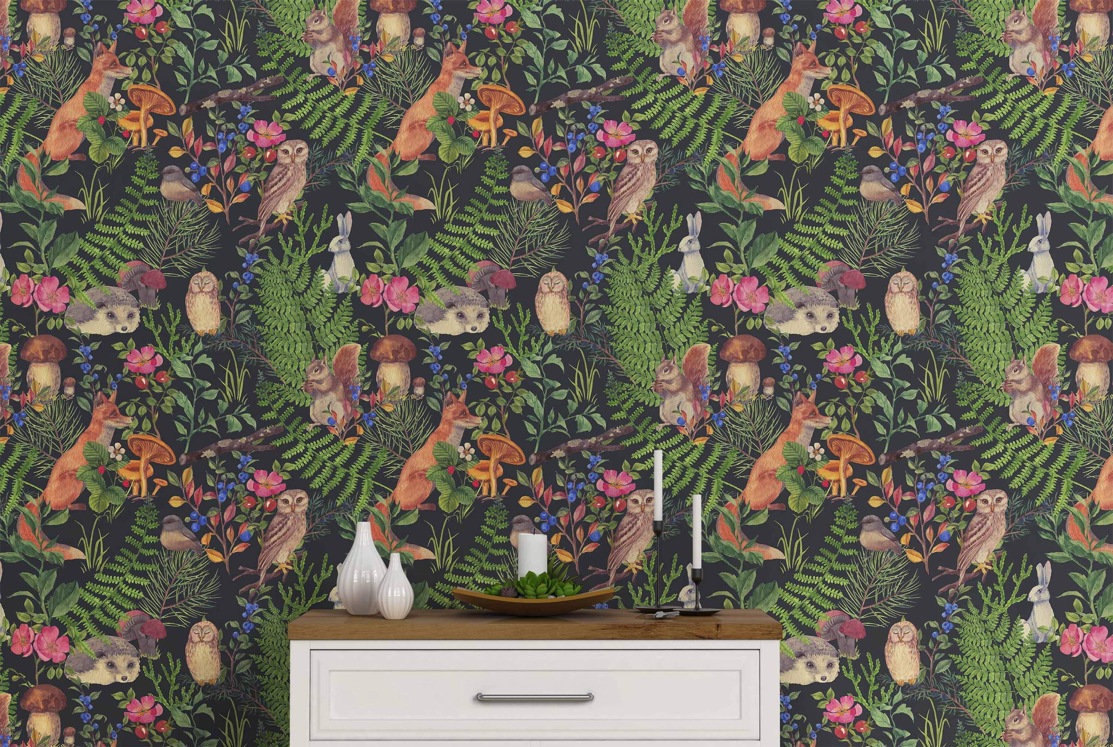 Watercolor woodland animal wallpaper with foxes, owls, squirrels, and hedgehogs amongst ferns, berries, and flowers on a dark background.