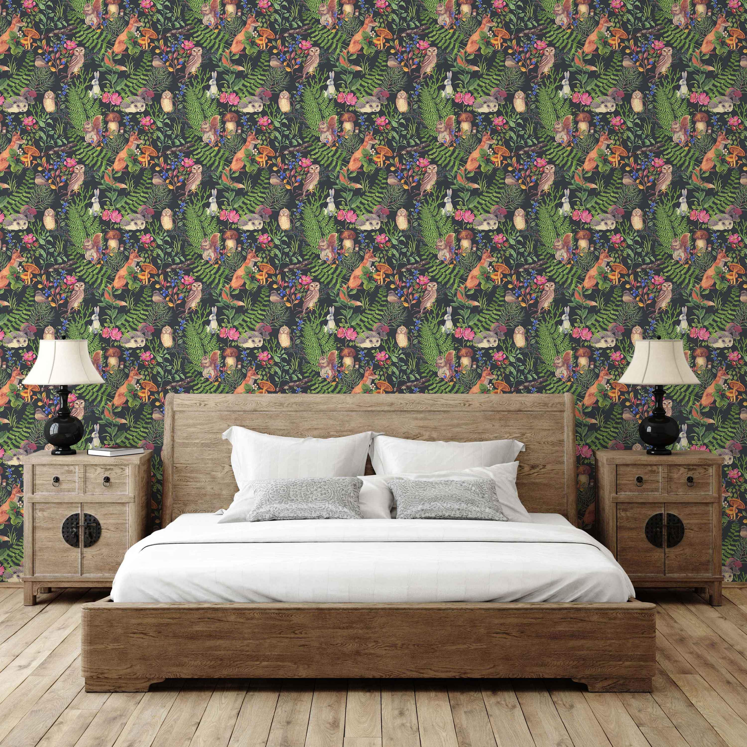 Illustrated woodland animals wallpaper with foxes, owls, squirrels, rabbits, and hedgehogs among ferns, flowers, and mushrooms on a dark background.