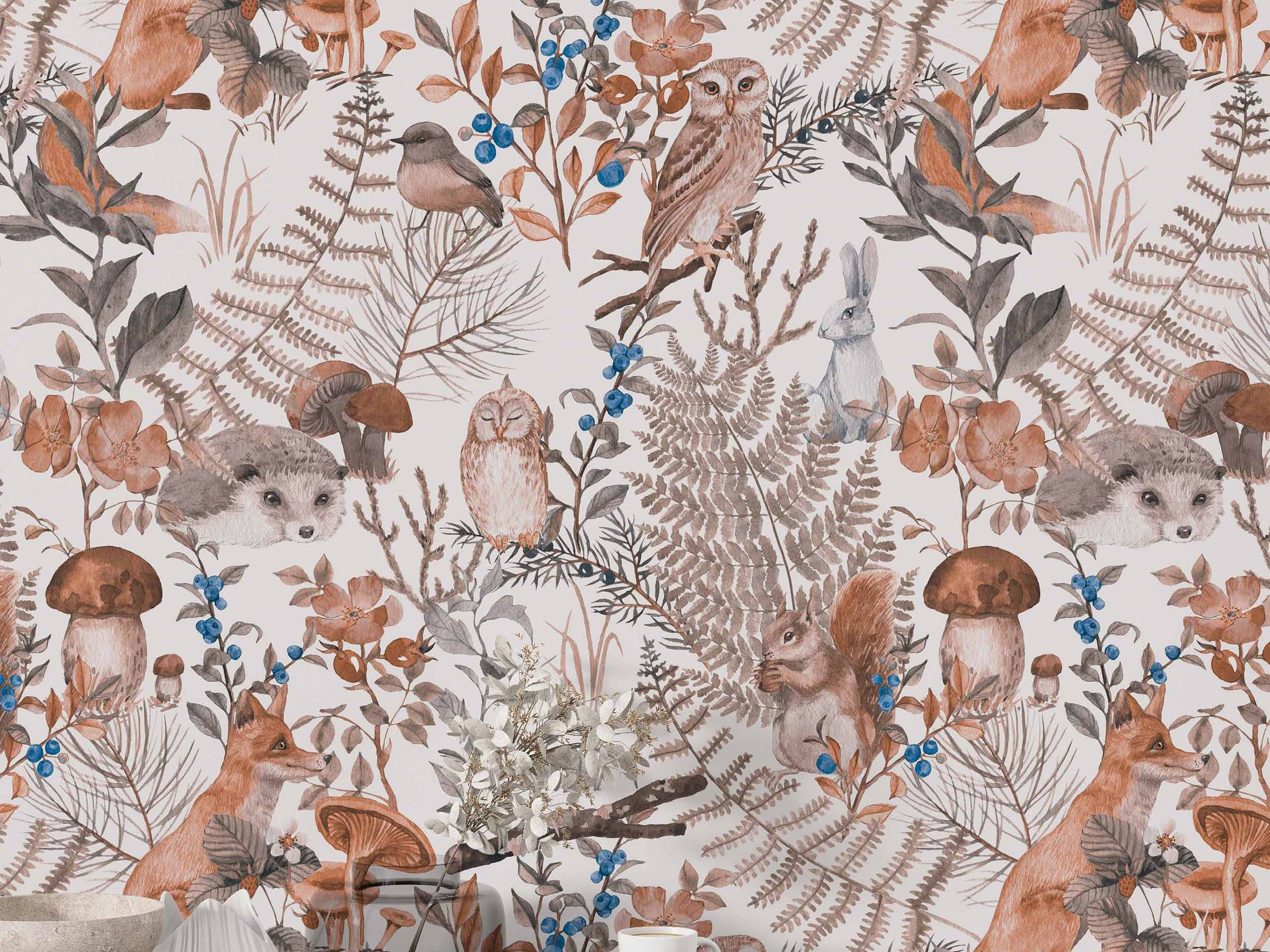 Watercolor woodland wallpaper featuring foxes, squirrels, owls, ferns, and berries in muted brown, gray, orange, and blue tones.