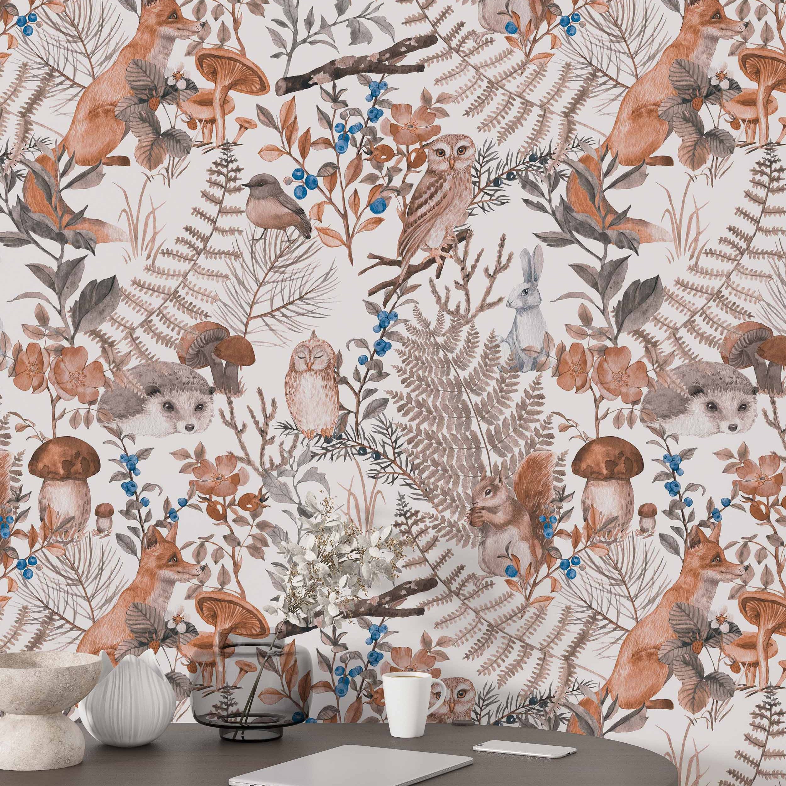 Watercolor woodland wallpaper featuring foxes, squirrels, owls, ferns, and berries in muted brown, gray, orange, and blue tones.