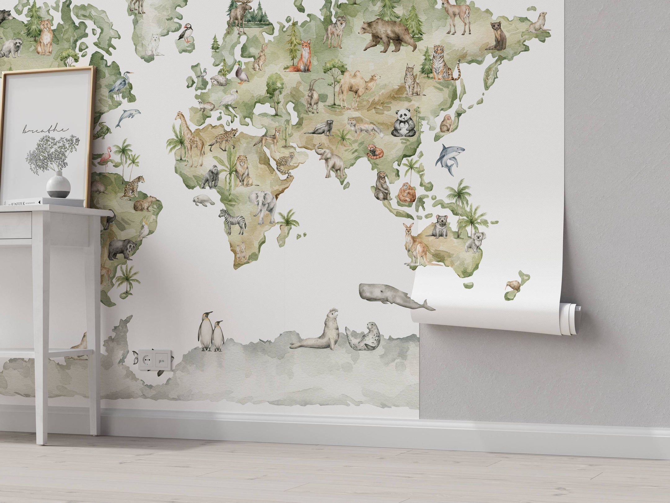 Watercolor world map mural in green and beige, featuring illustrations of animals on their respective continents.