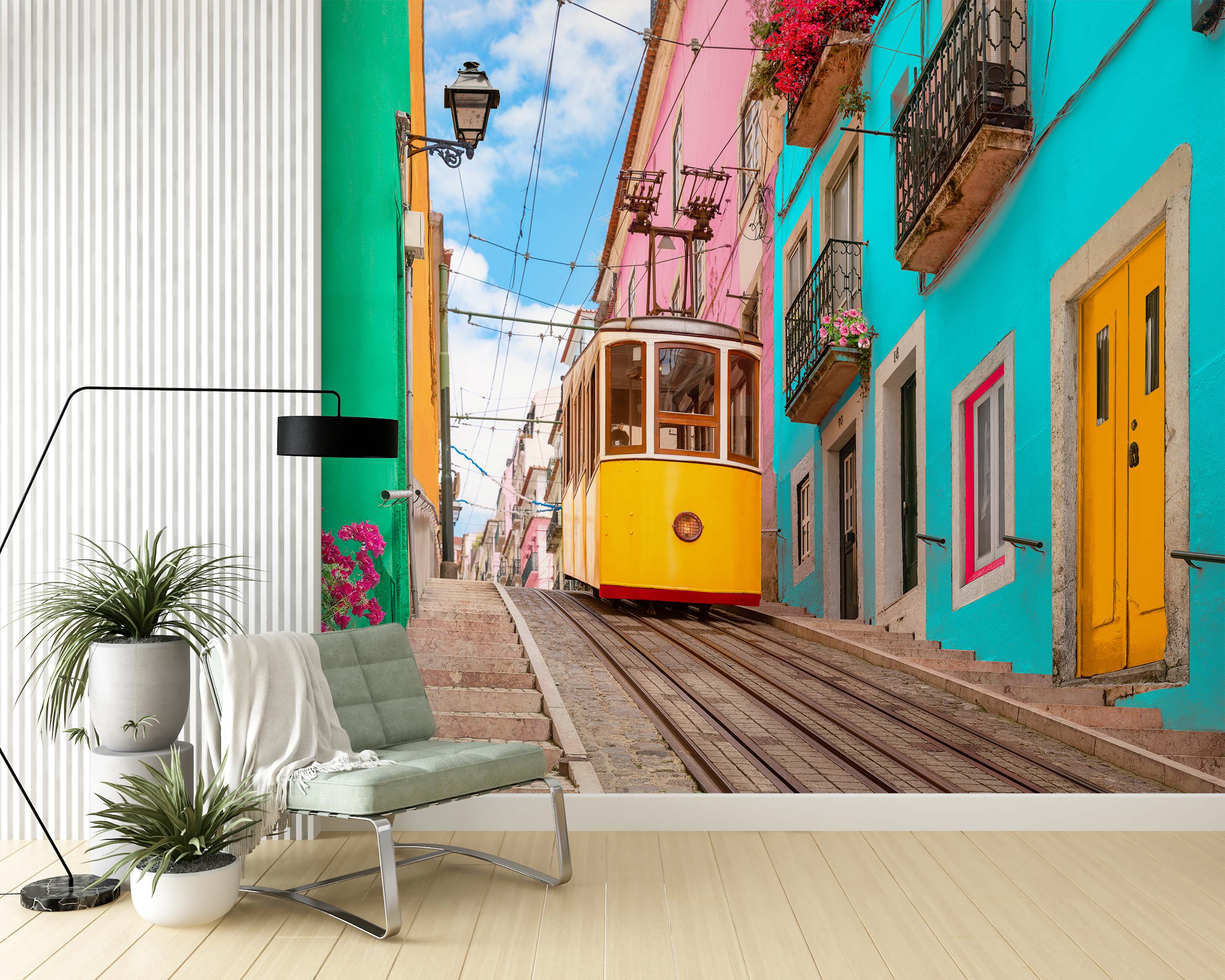 A vibrant city scene mural featuring a yellow tram on a steep cobblestone street, lined with colorful pink and turquoise buildings.