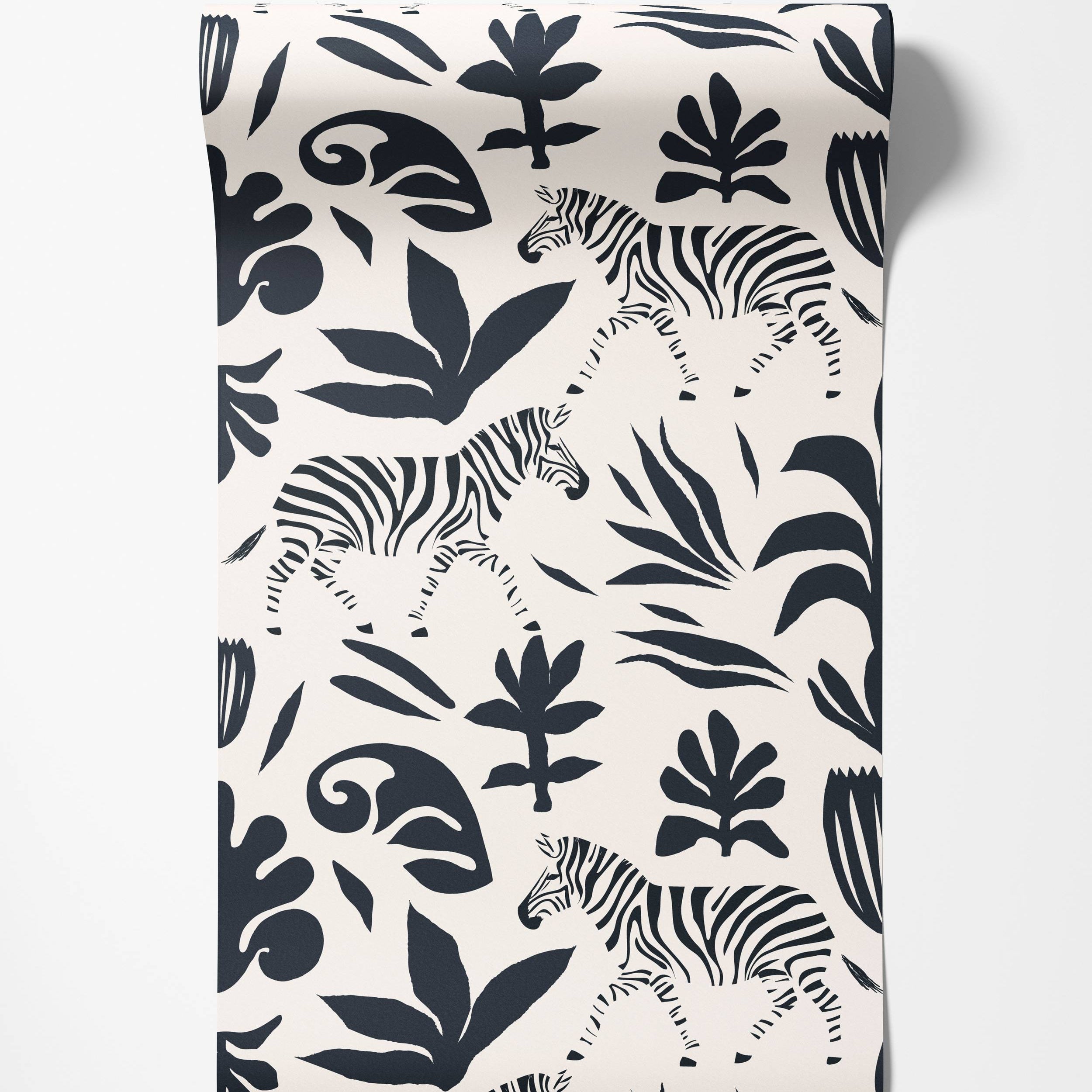 Wallpaper with a bold black print of zebras and stylized botanical elements on a cream background.
