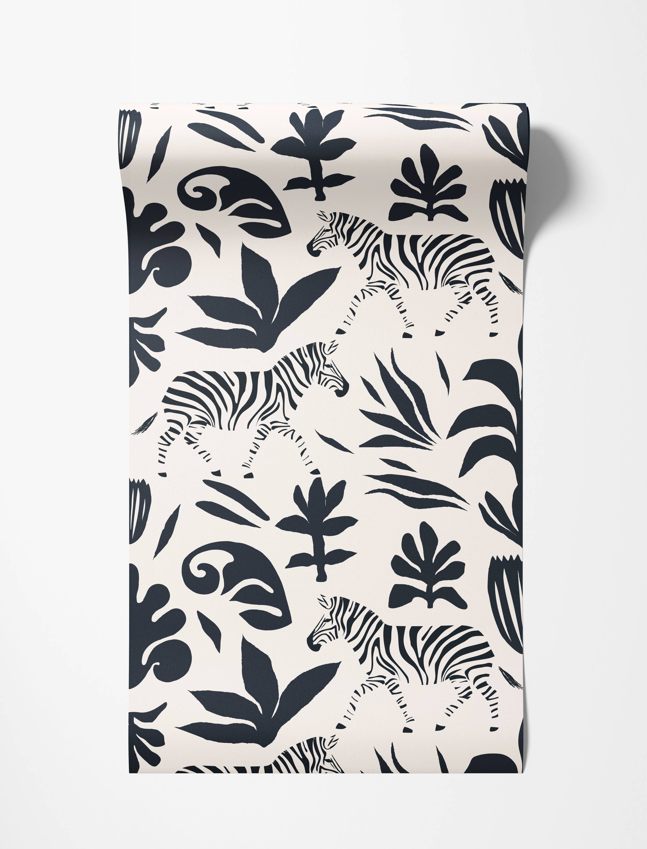 Wallpaper with a bold black print of zebras and stylized botanical elements on a cream background.